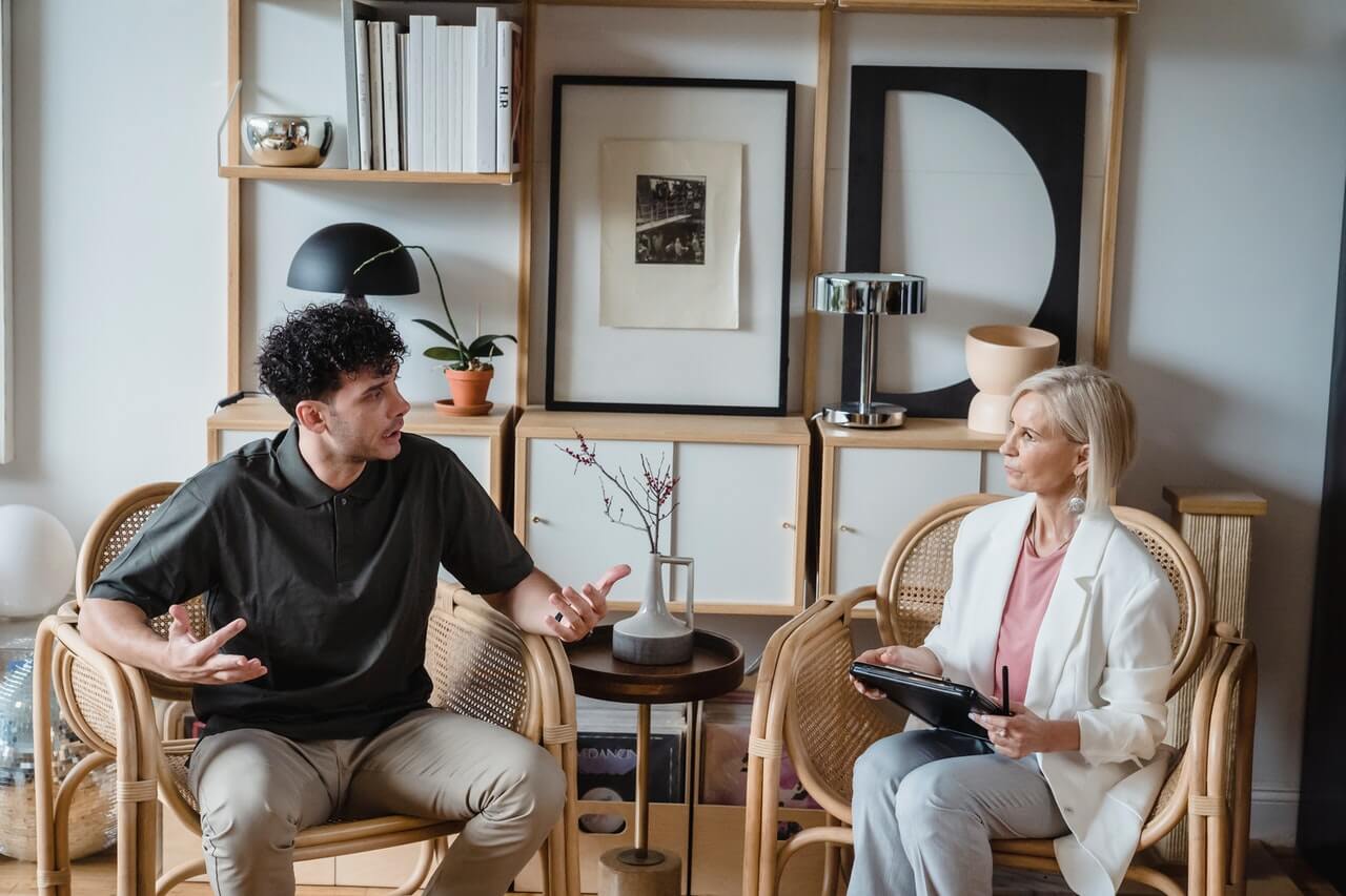 a man talking to a woman while she listen to him