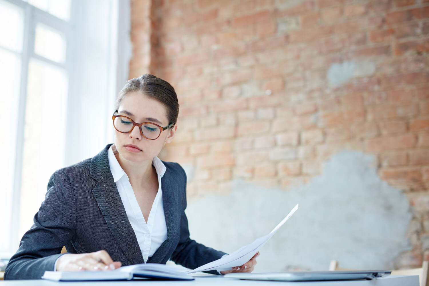 An-auditor-going-through-documents-in-her-office