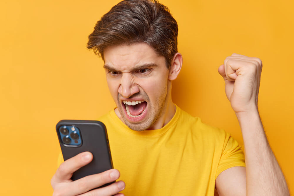 An-man-outraged-while-going-through-his-phone