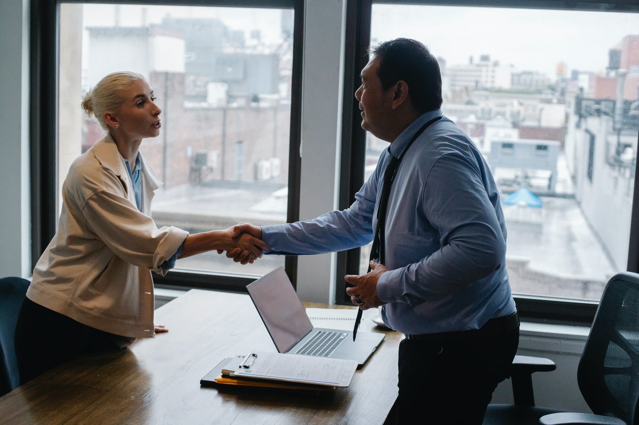 A lady shaking hands with her partner