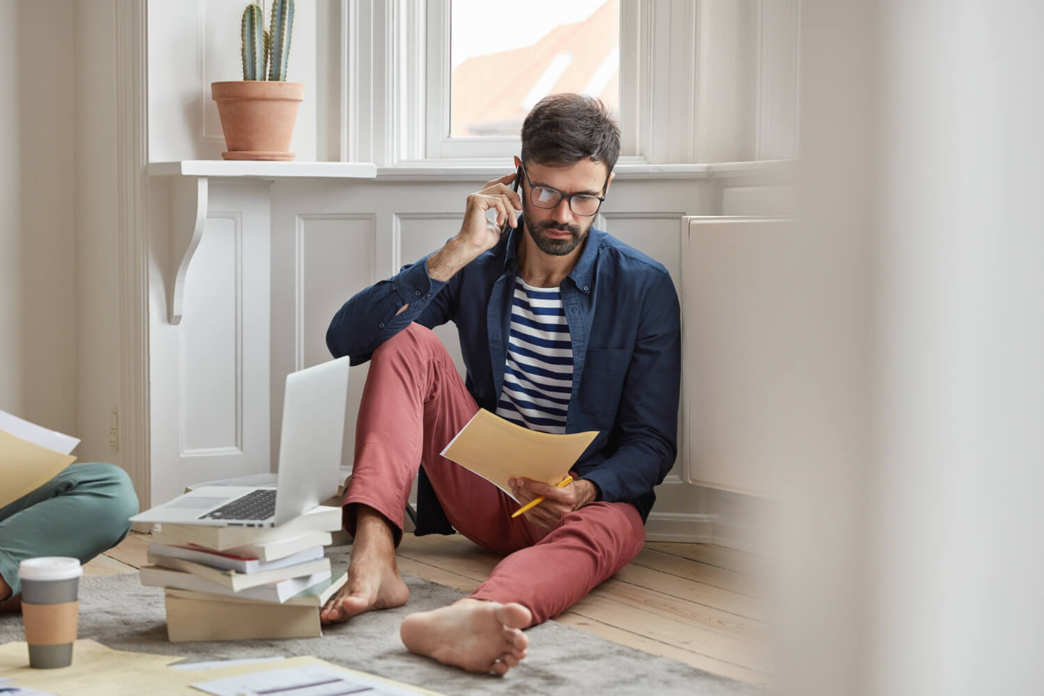 Businessman going through a document sitting on the floor