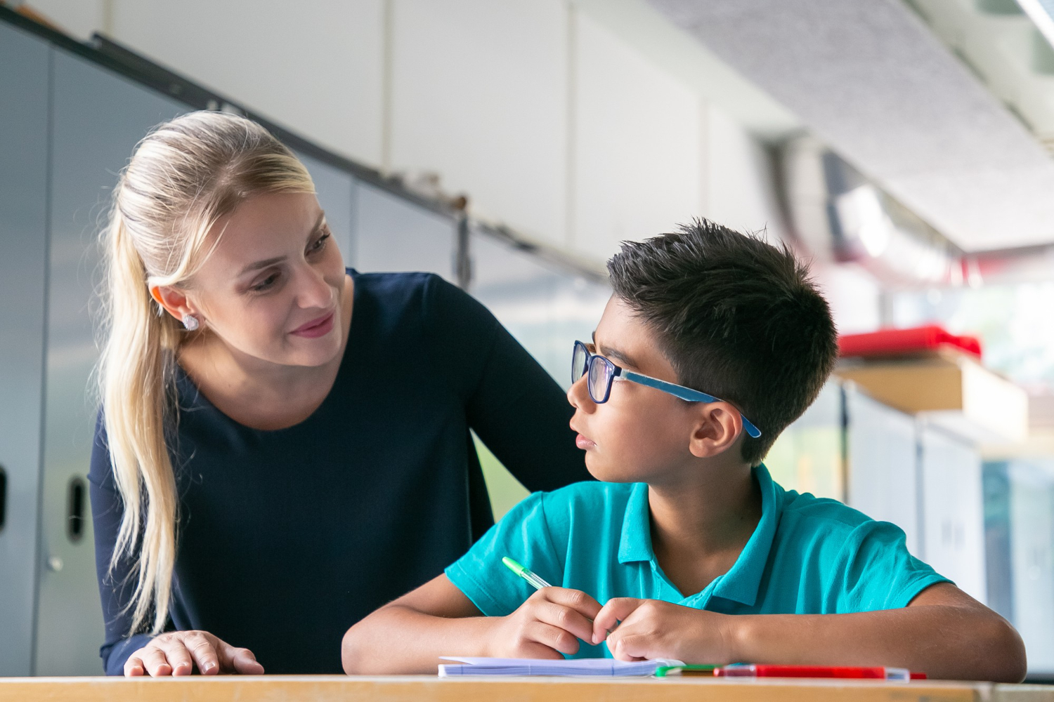 Cheerful teacher giving love and support to her student