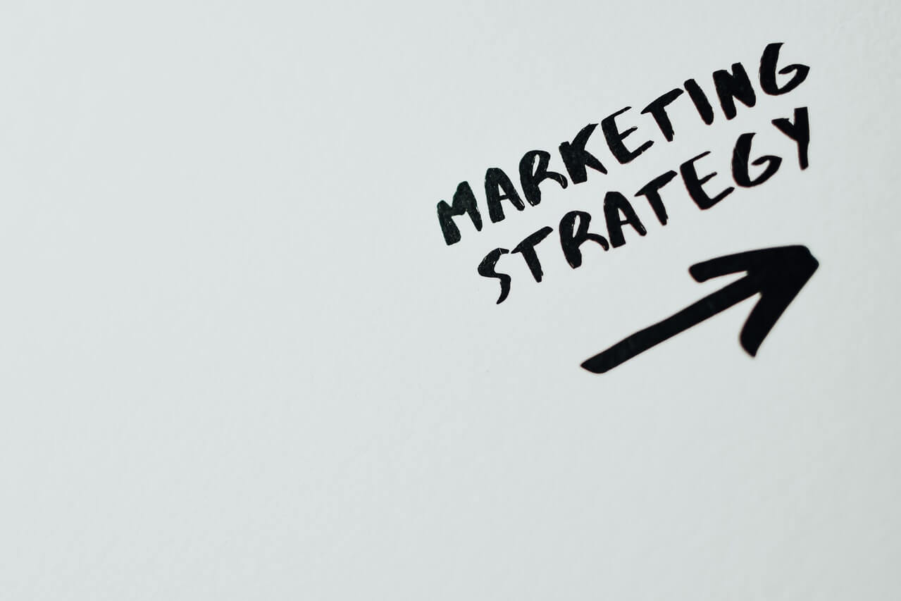 Close view of marketing strategy with an arrow pointing forward