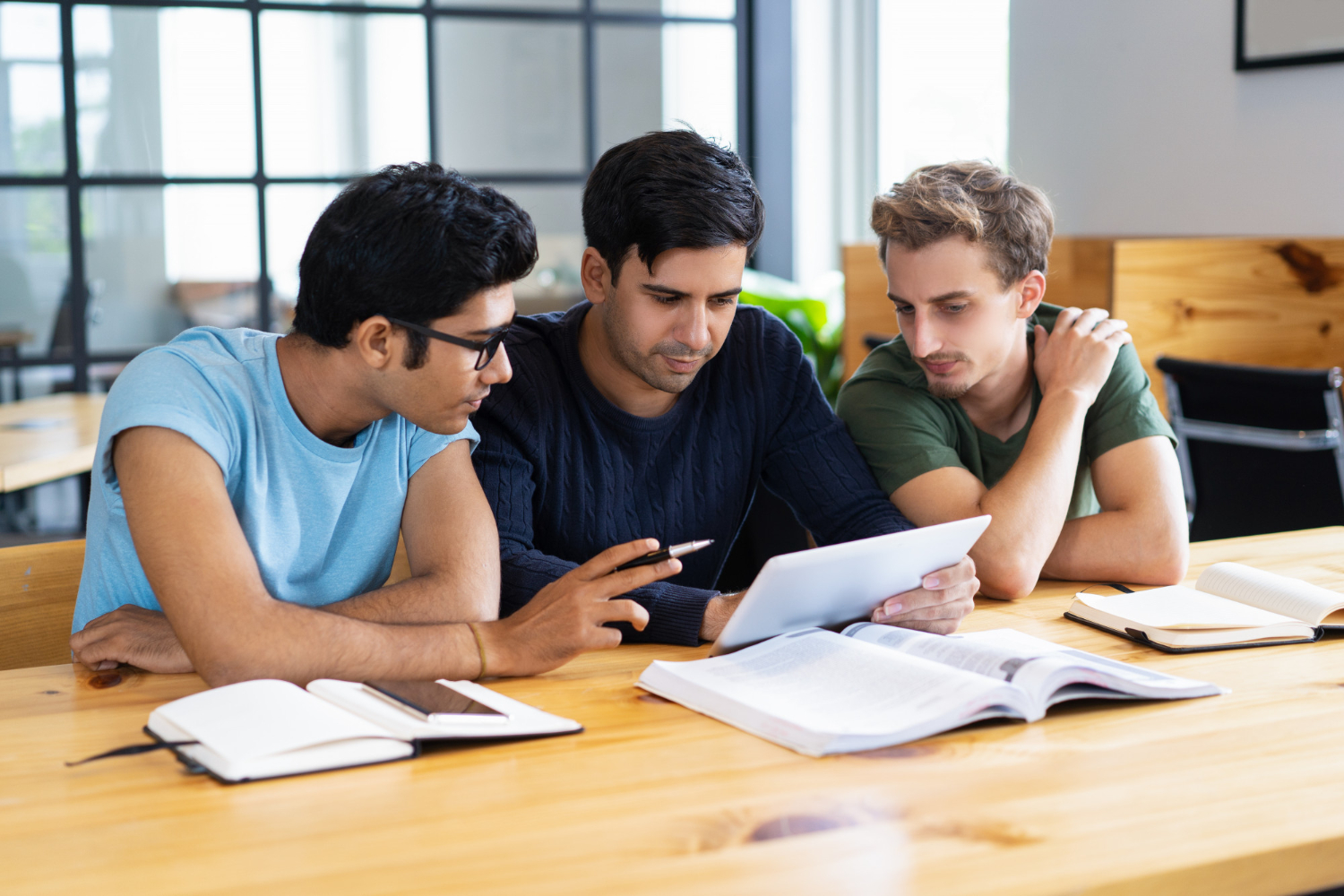 Focused group of boys using a tablet