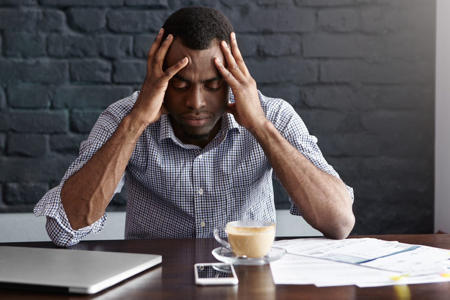 Stressed young business man having headache because of a bug