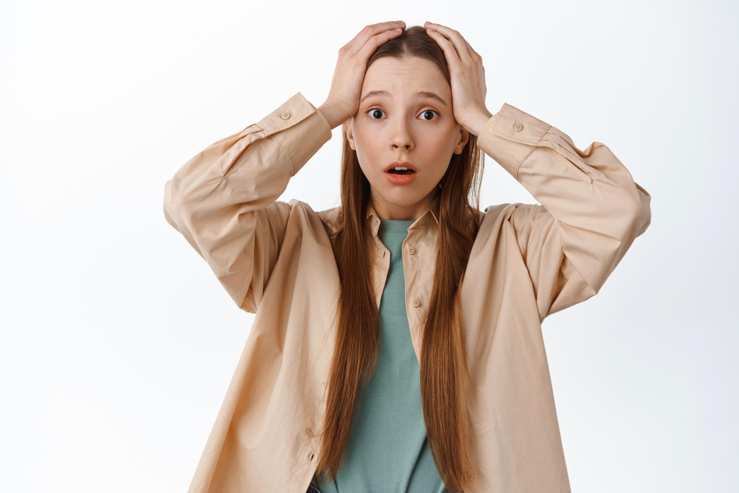 A young lady with a shocked expression looking worried