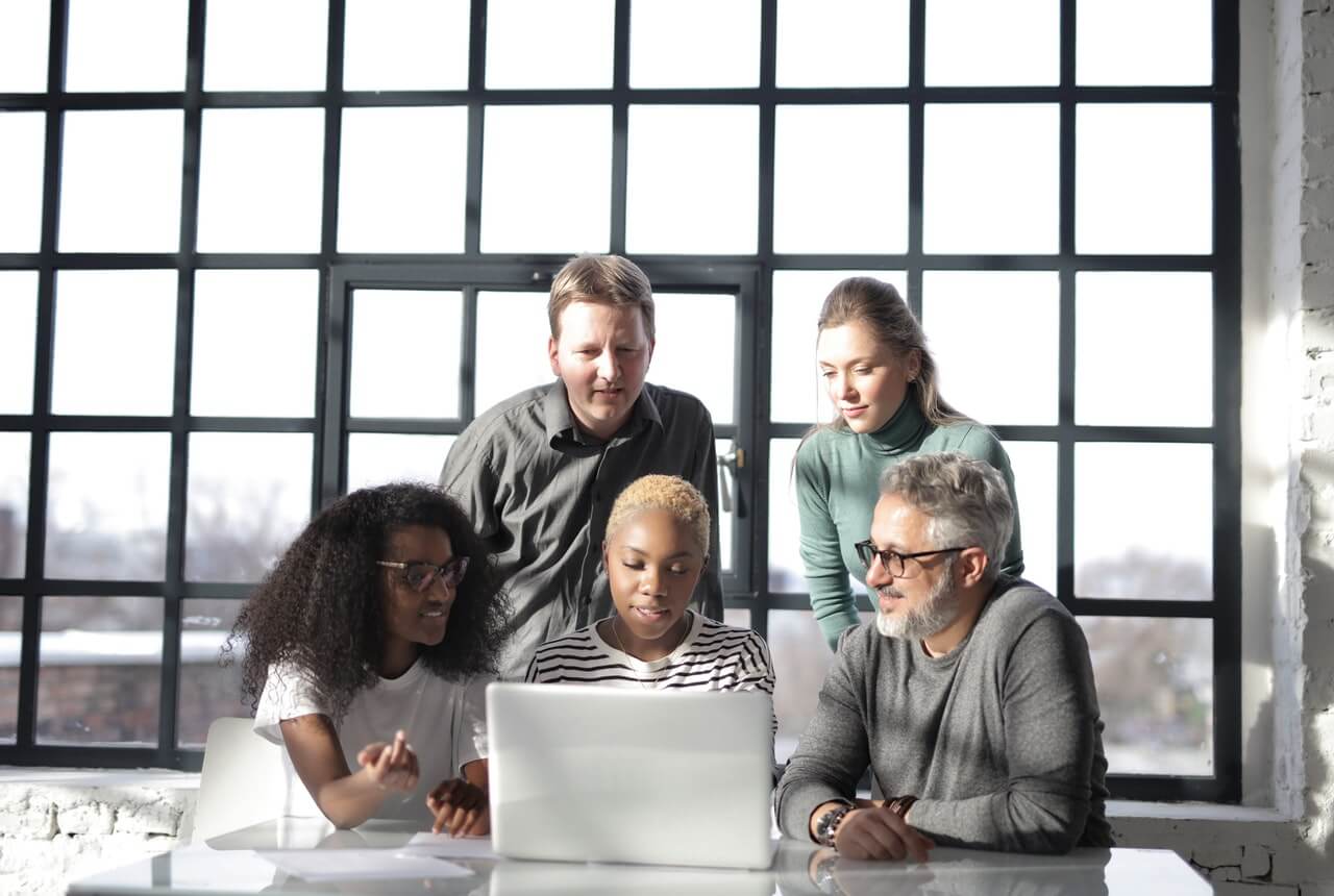 Group-of-colleagues-working-with-an-internet-connected-laptop