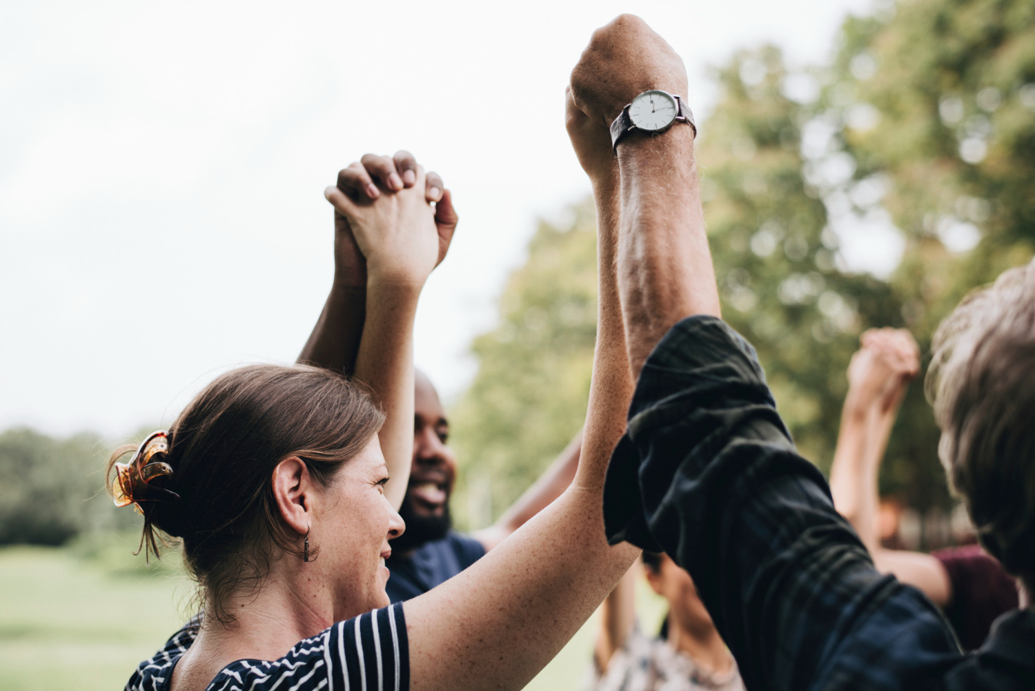 Group of people holding hands together