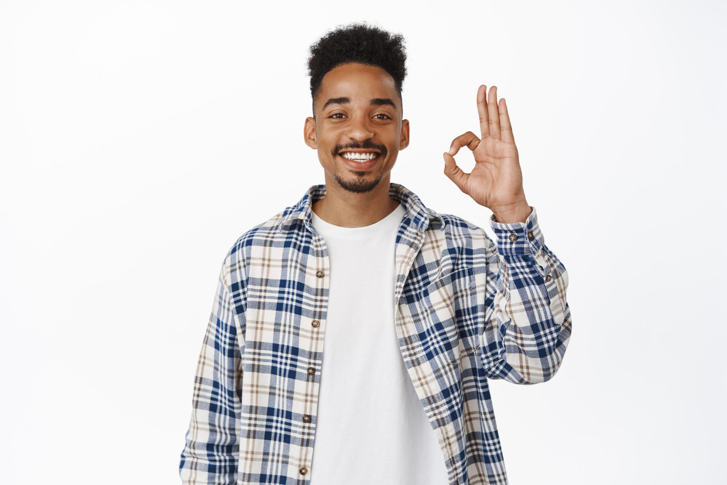 Satisfied smiling man showing okay sign with his hand