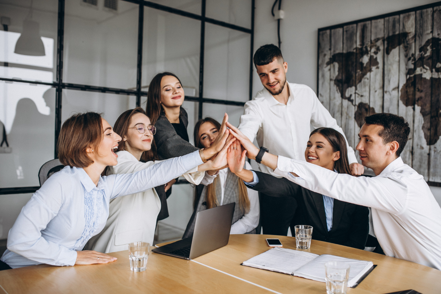 Team rejoicing working together on a project in an office