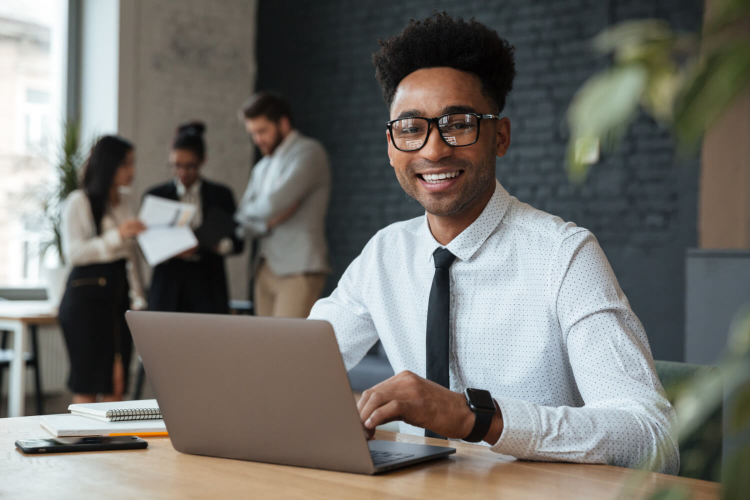 Young employee smiling while working