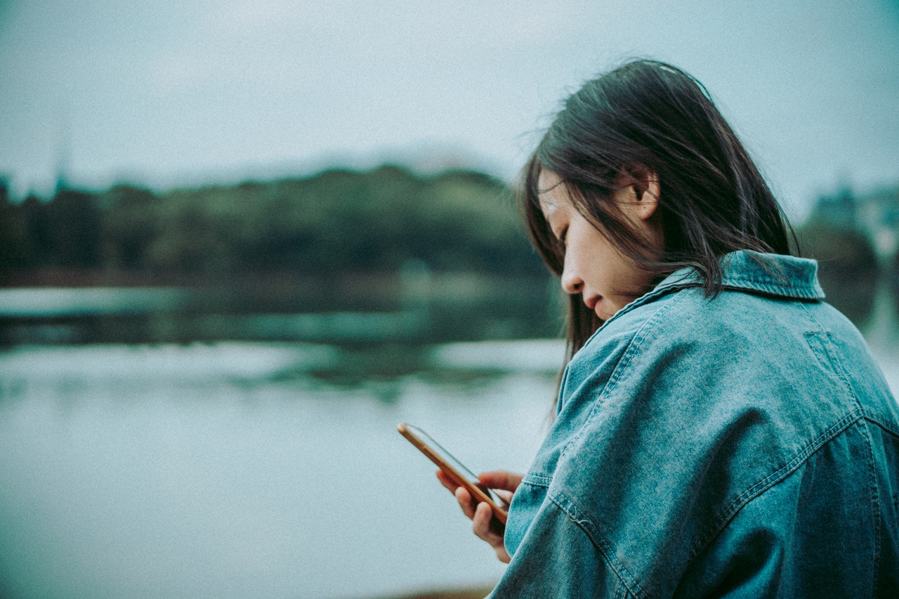 A lady looking on her smartphone