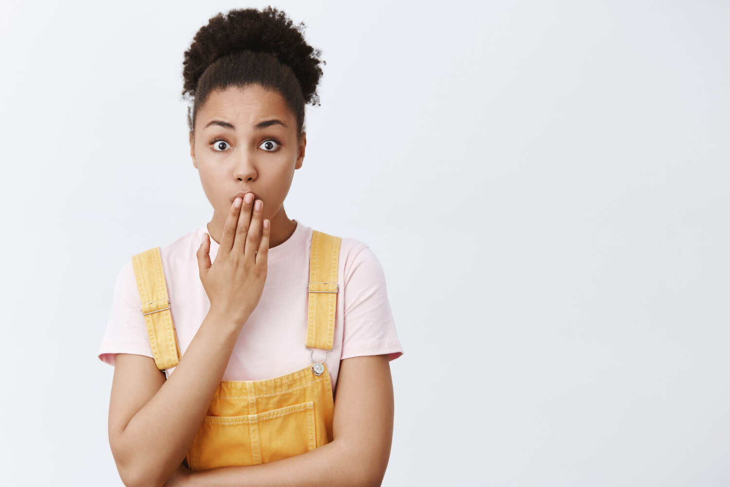 Lady looking embarrassed and surprised covering her mouth