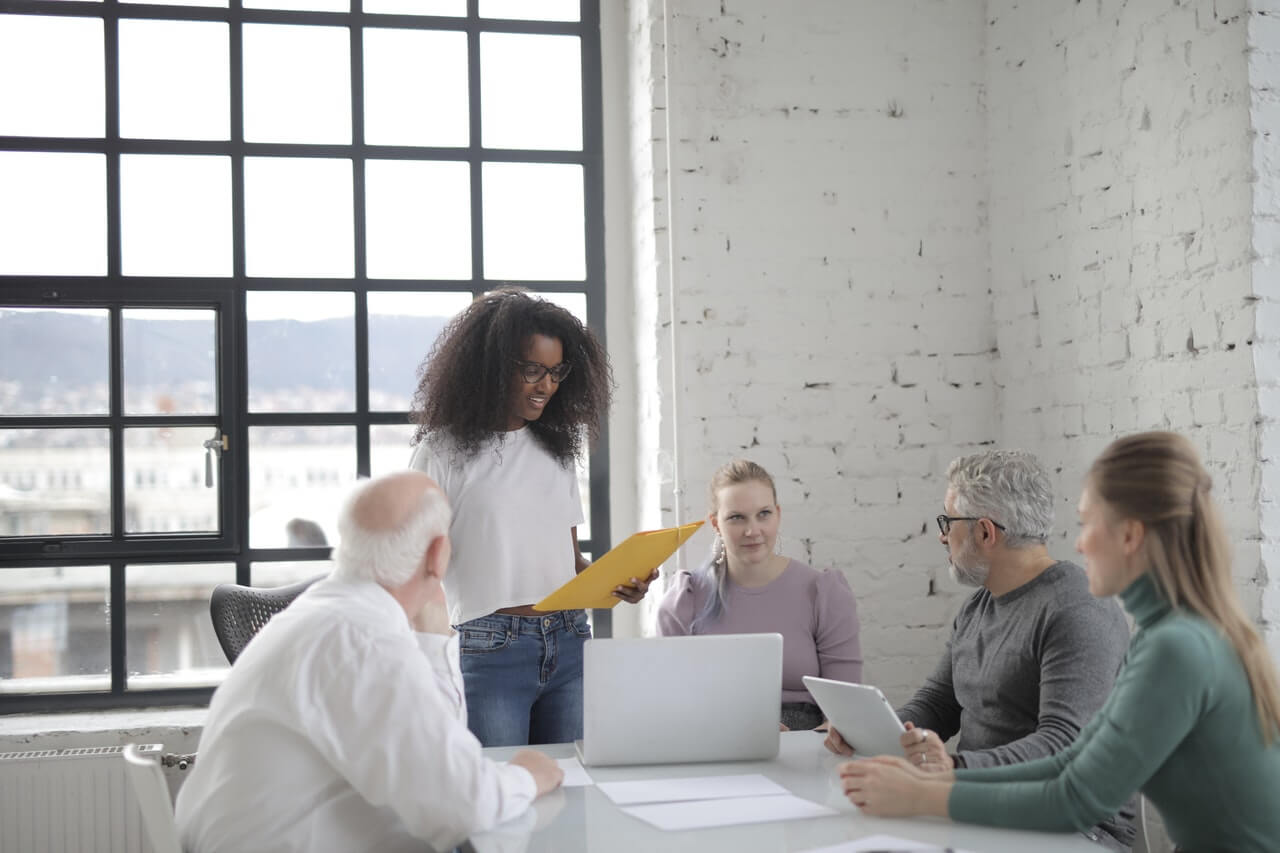 Woman smiling while presenting to colleagues