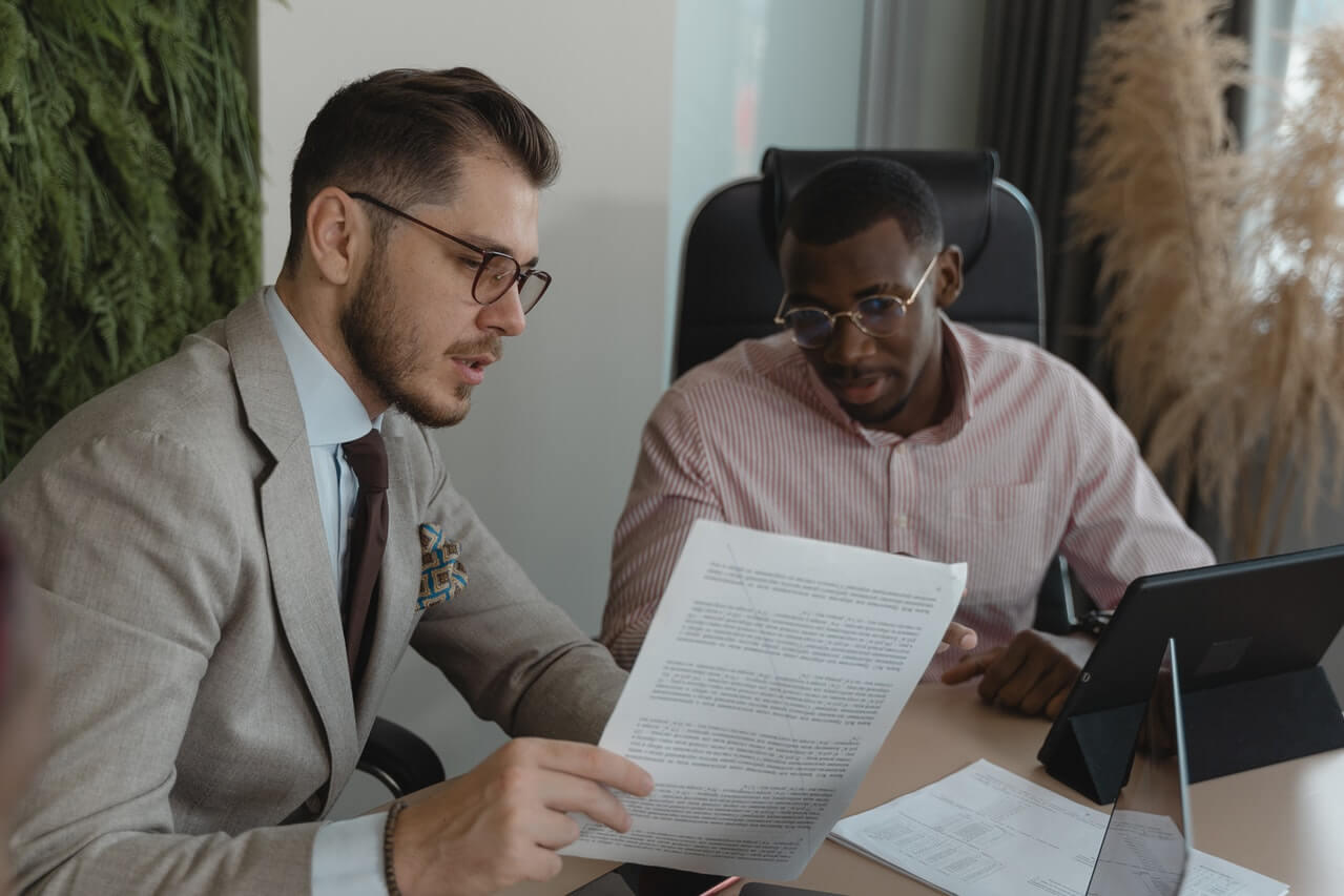 Two young men reviewing documents