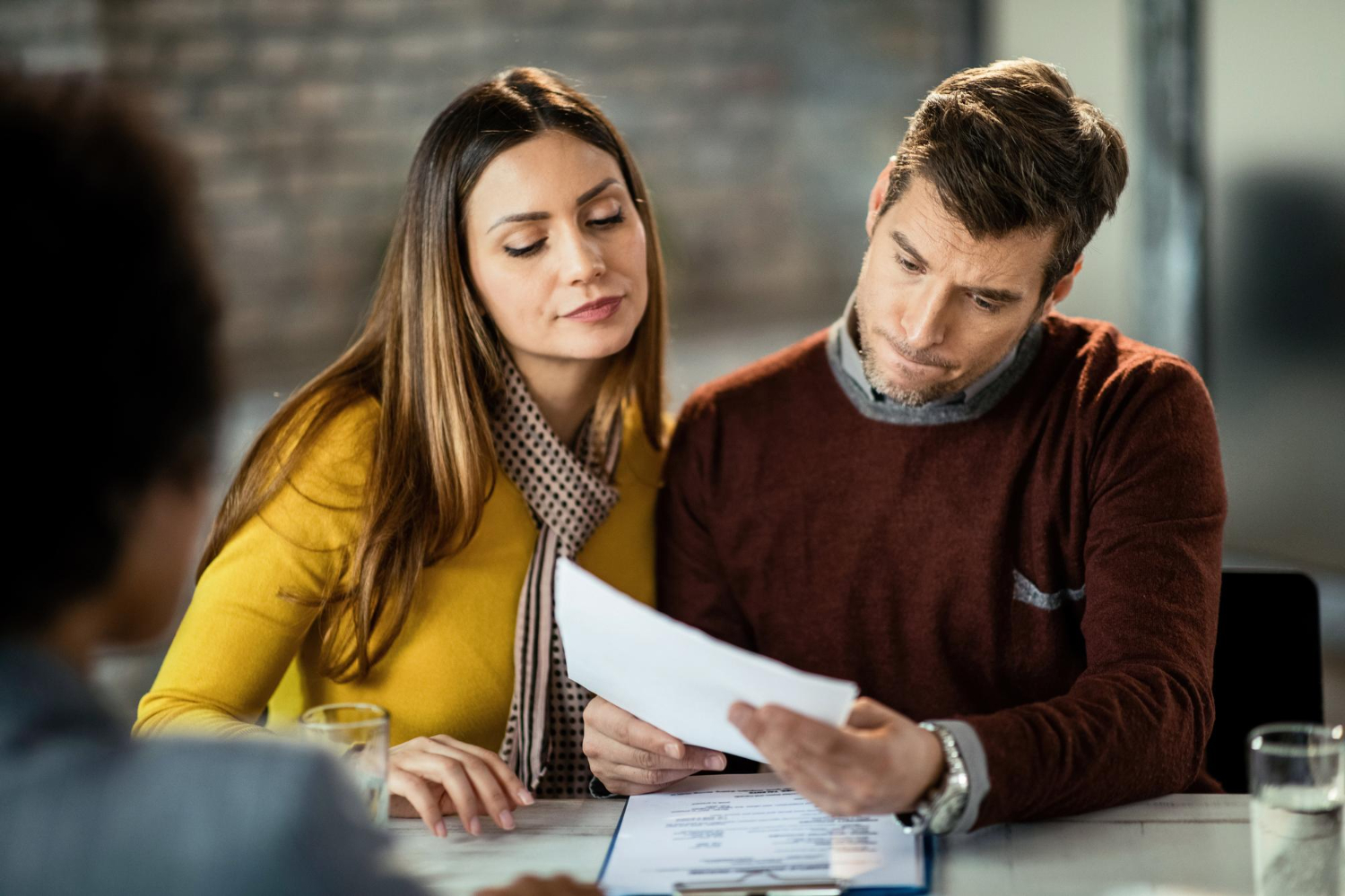 Uncertain-couple-having-doudts-in-signing-a-financial-document