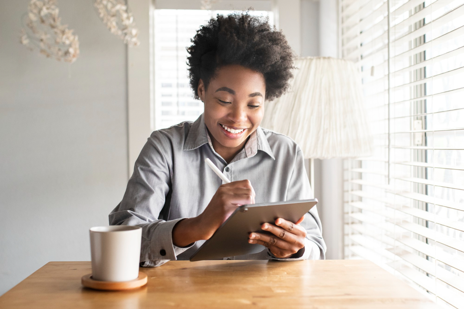 Smiling woman reading with a tablet