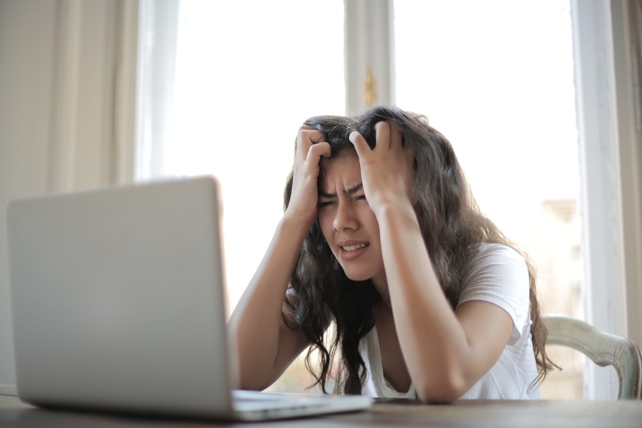 Stressed and frustrated woman trying to work