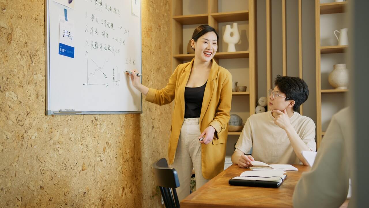 Woman Presenting at a Meeting