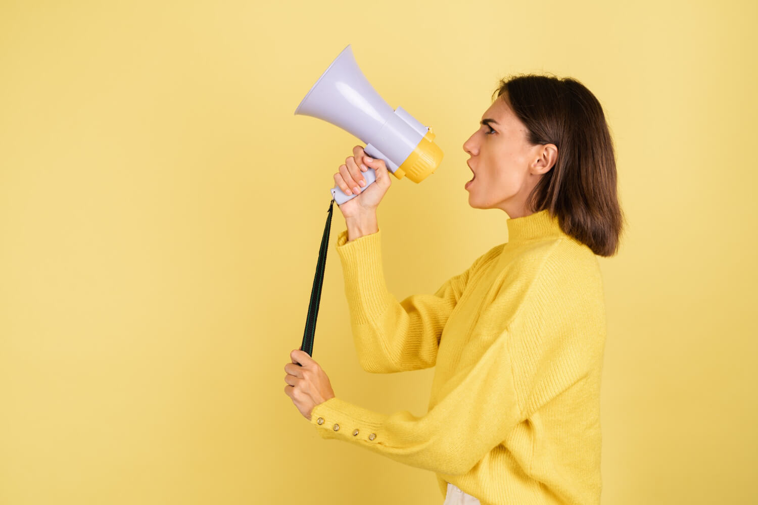 Young lady screaming into megaphone speaker