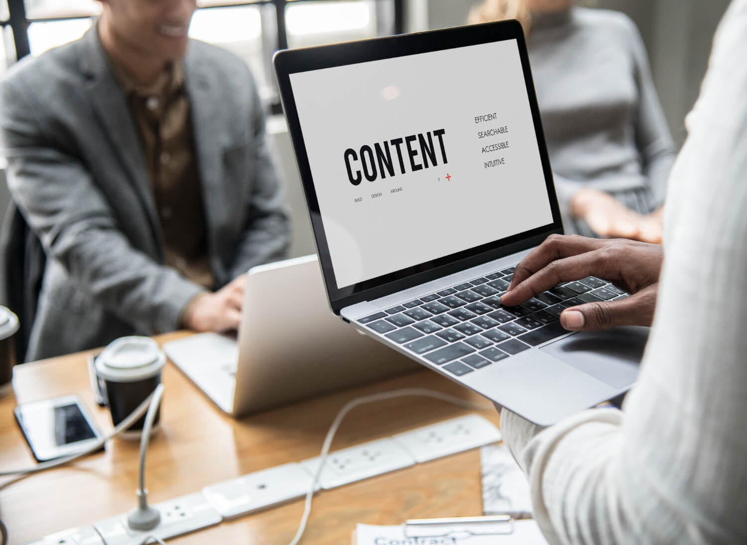 a lady holding a laptop with content concept on the screen