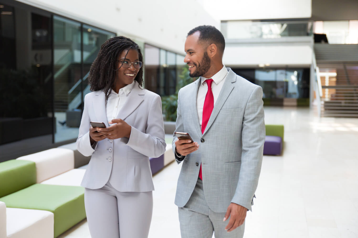 happy-business-colleagues-using-mobile-phones-chatting