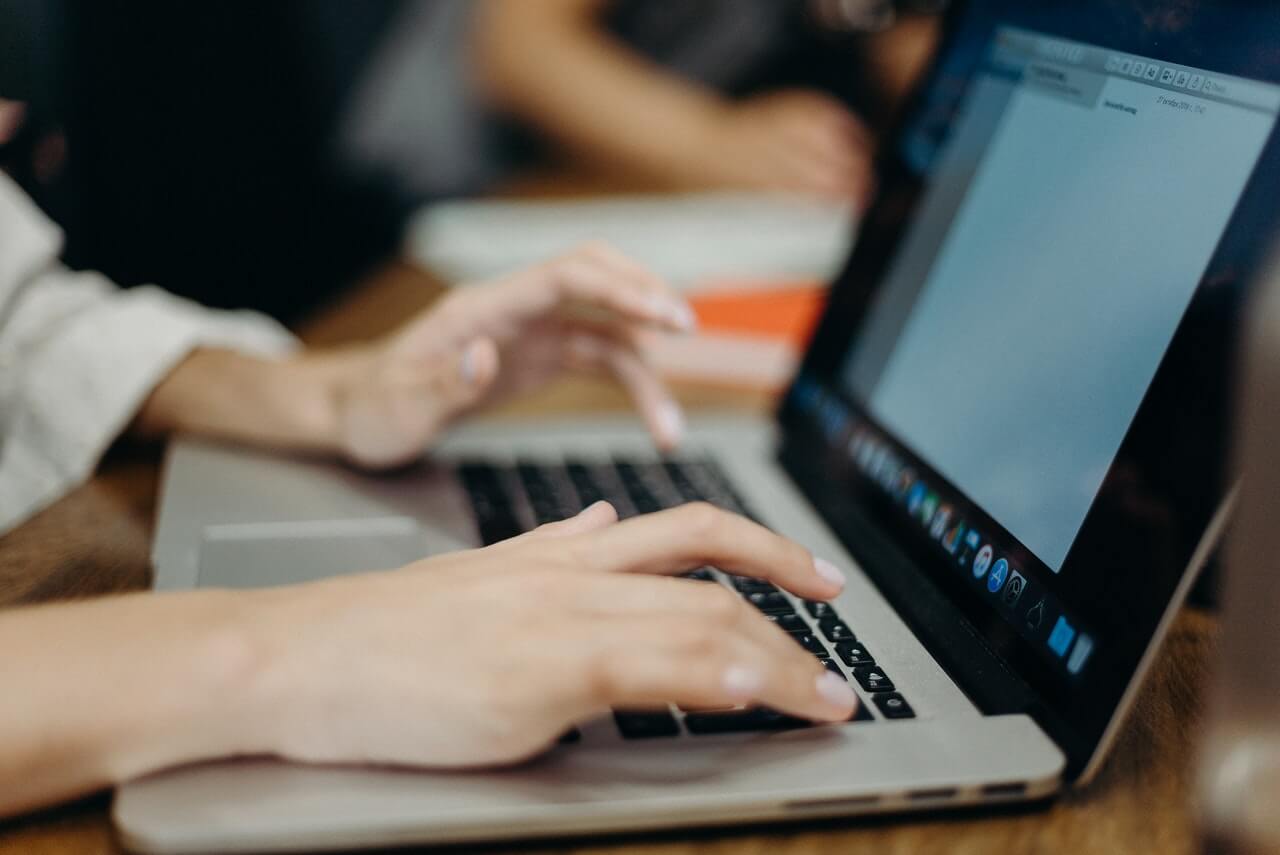 A lady typing on a laptop