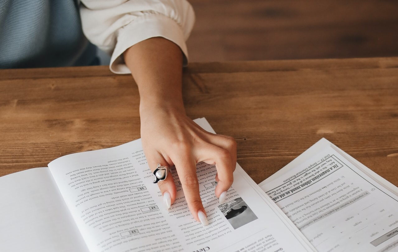 A lady's hand on a user guide