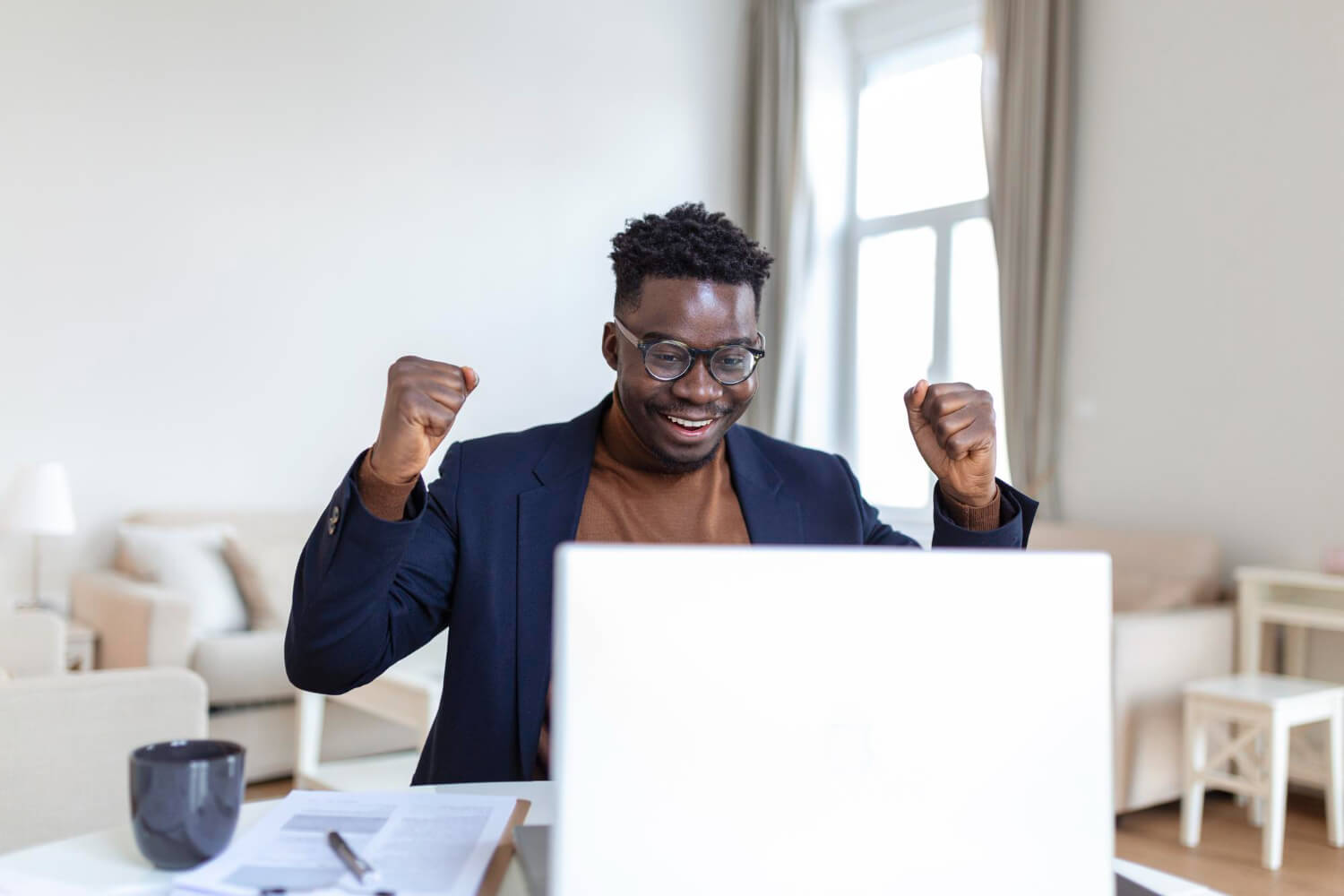 A-man-excited-after-talking-with-a-possible-client-with-his-laptop