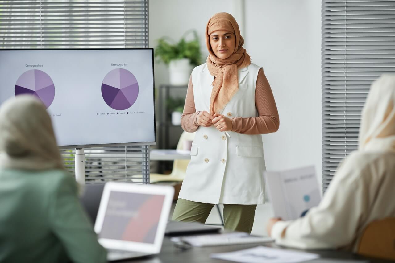 A woman presenting with slides