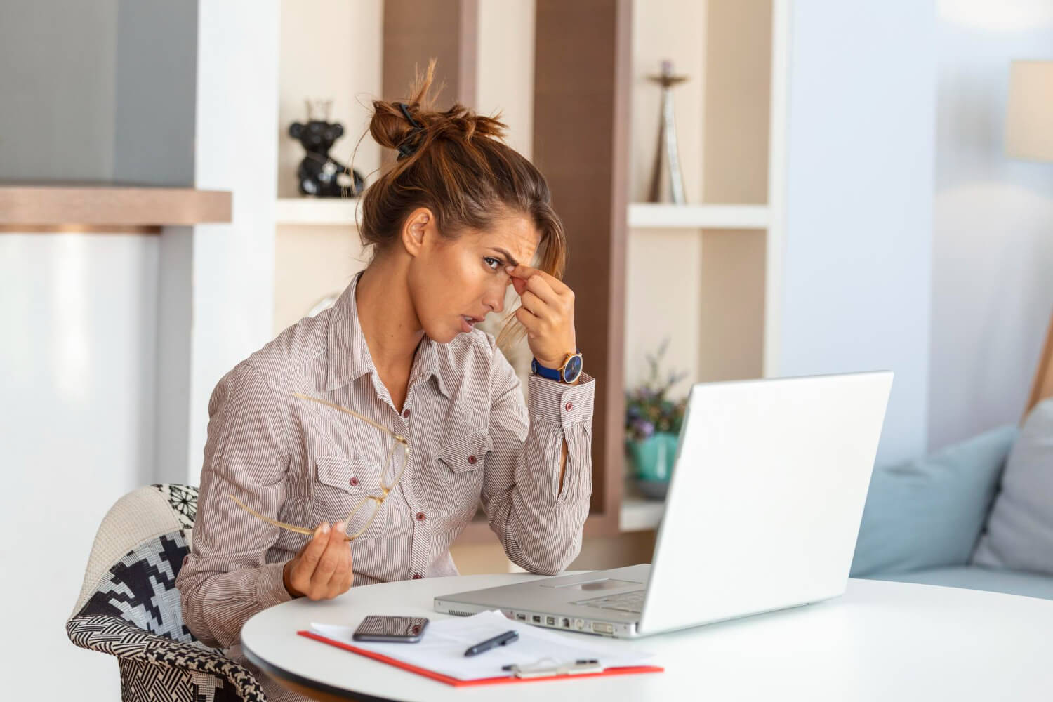 A-young-woman-thinking-and-making-plans-with-her-laptop