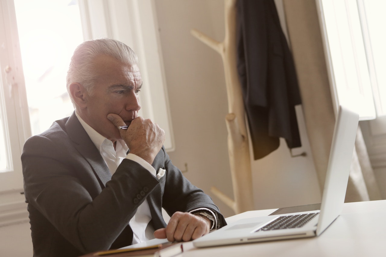 An-employer-thinking-while-working-in-his-office.