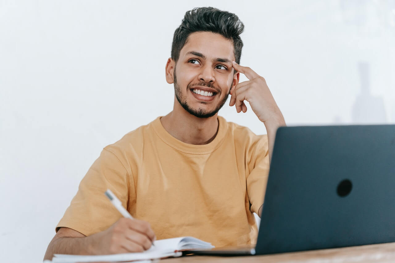 Businessman thinking while making a note