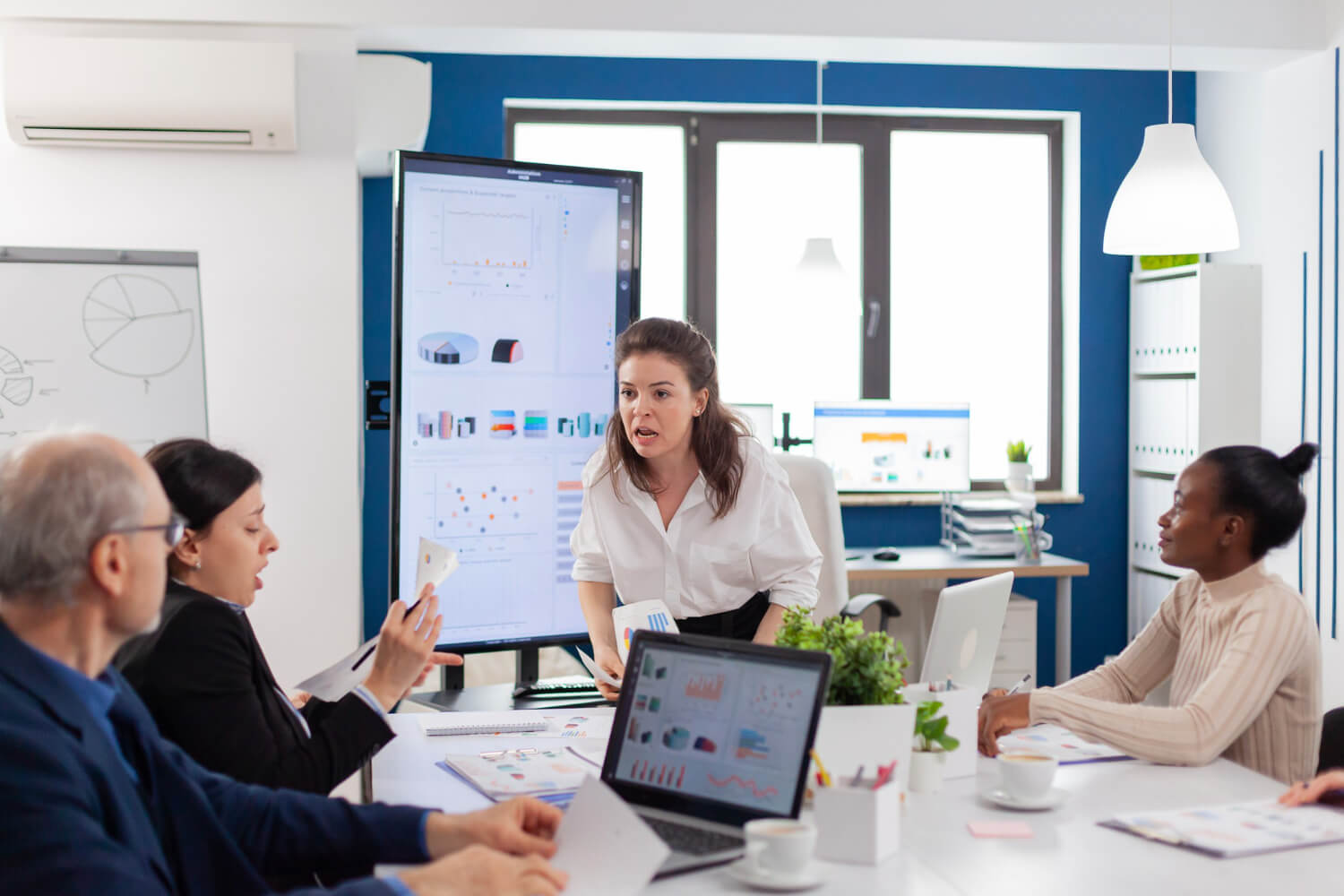 Boss screaming angrily at employee during meeting