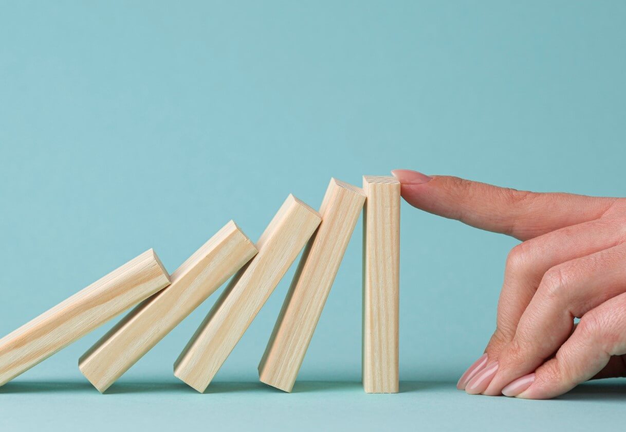 Abstract of a finger stopping falling wooden pieces