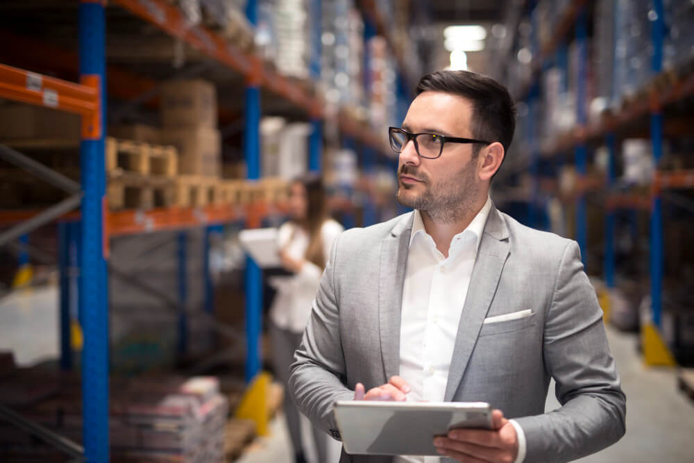 A wholesale distributor taking inventory of his warehouse