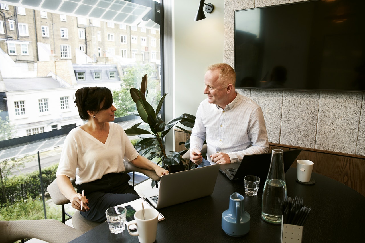 A businessman consulting with a young professional