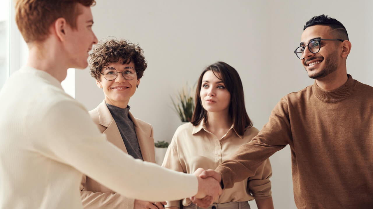 People having an handshake happily