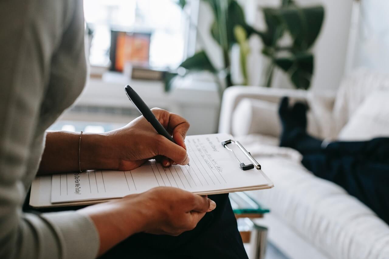 Person-carefully-writing-a-report-in-an-office