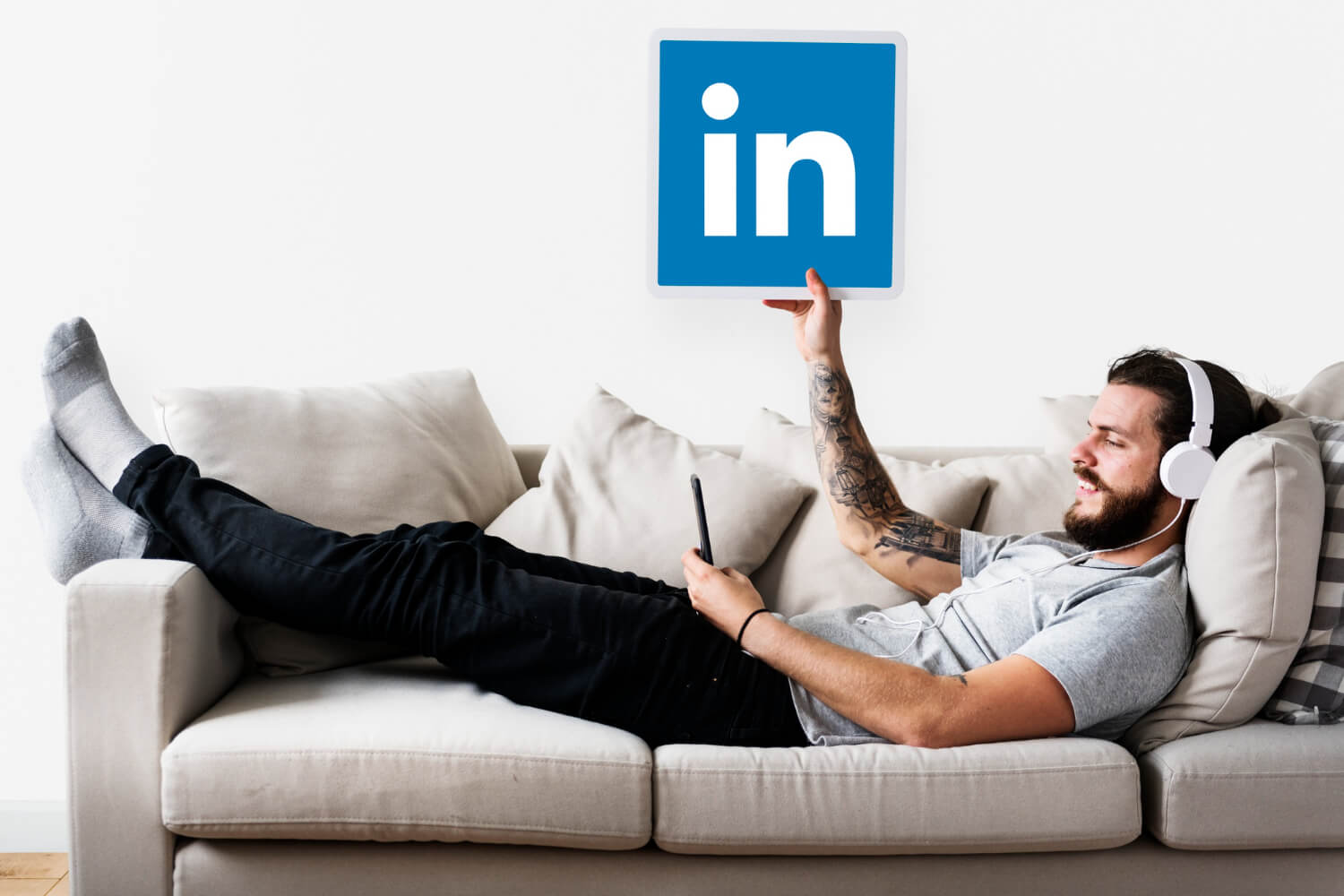 Person holding linkedin icon