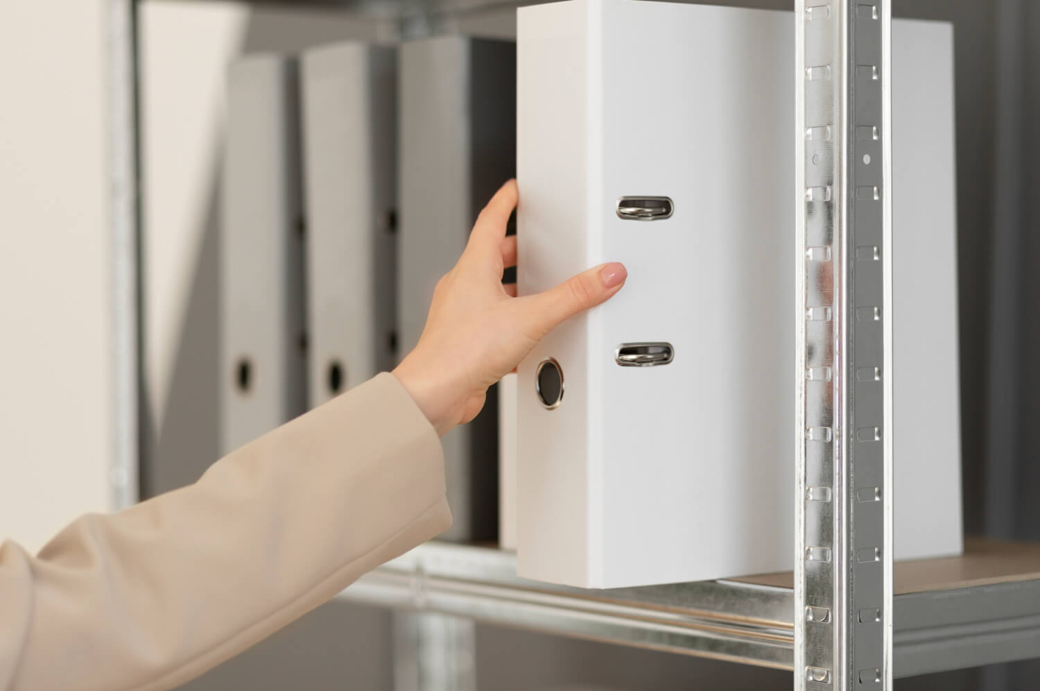 Young lady organizing documents on a shelf