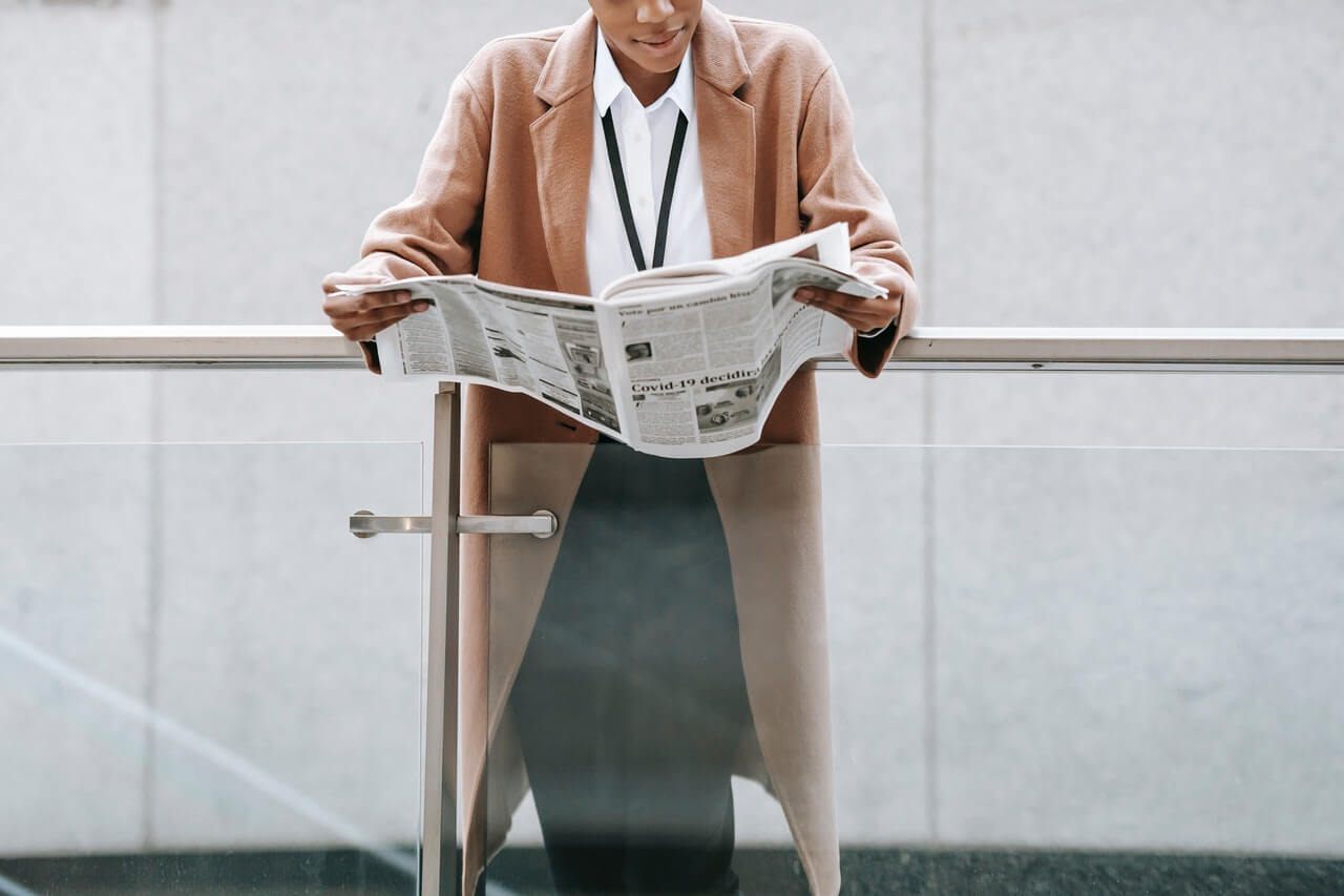 Young lady reading a newspaper