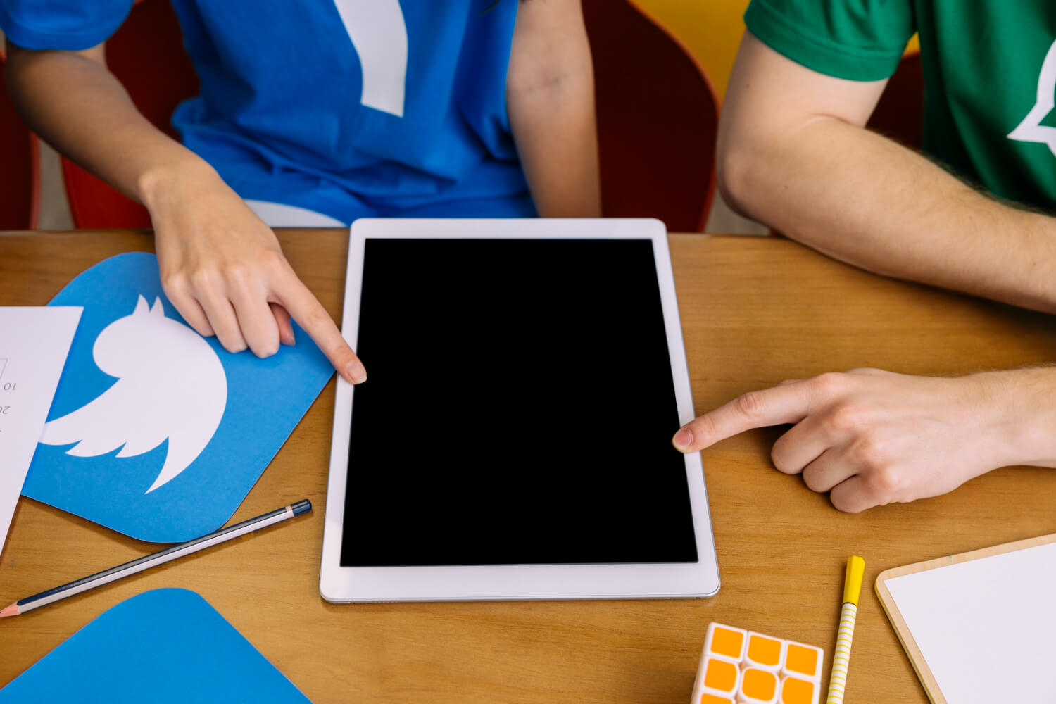 two-users-pointing-digital-tablet-with-blank-screen