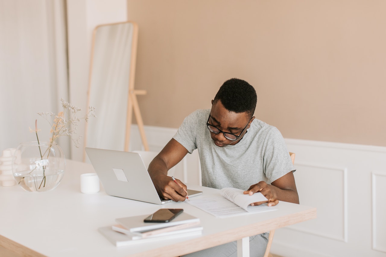 A Man in Gray T-shirt Writing