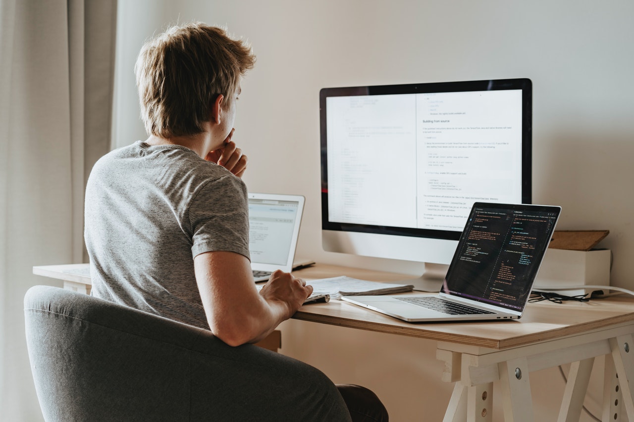 A-programmer-working-with-a-desktop-in-his-apartment-