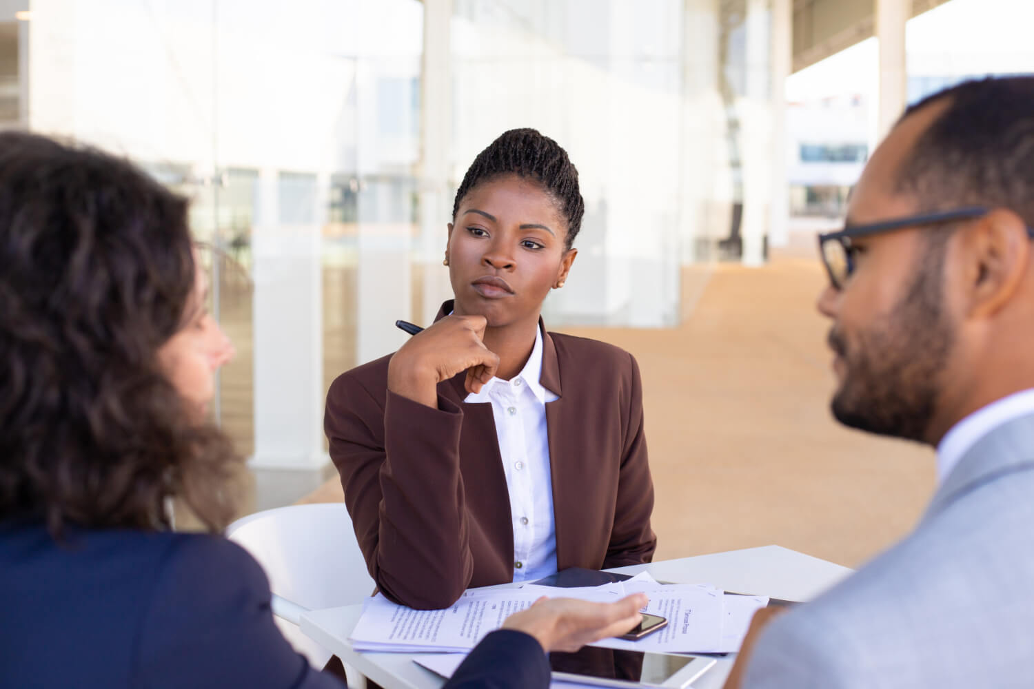 A-woman-interviewing-a-man-and-a-woman-for-a-job