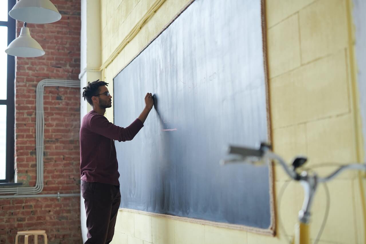 A young man writing on the board