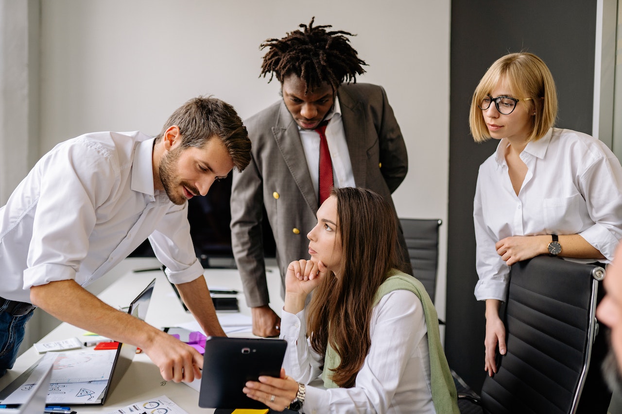 Colleagues working Together While looking at a Tablet