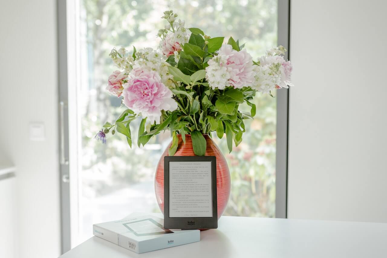 Potted Pink Petaled Flower Near Black Tablet