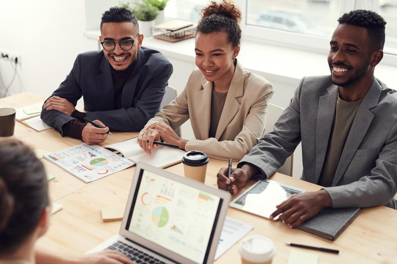 A group of work colleagues happily working on a project